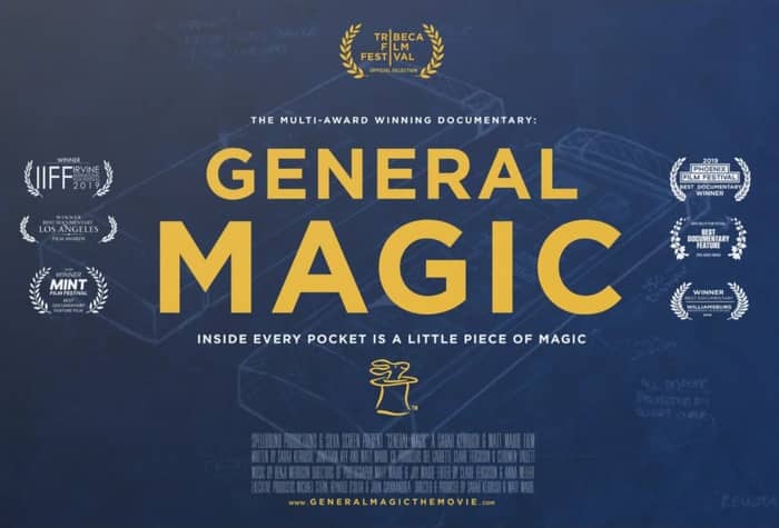 A promotional poster for the documentary film 'General Magic', featuring the title in large yellow font over a blue blueprint background of a handheld device.. Text: TRIBECA FILM FESTIVAL OFFICIAL SELECTION
THE MULTI-AWARD WINNING DOCUMENTARY:
GENERAL MAGIC
INSIDE EVERY POCKET IS A LITTLE PIECE OF MAGIC
WINNER IIFF IRVINE INTERNATIONAL FILM FESTIVAL 2019
WINNER BEST DOCUMENTARY LOS ANGELES FILM AWARDS
2018 WINNER MINT FILM FESTIVAL BEST DOCUMENTARY FEATURE FILM
2019 PHOENIX FILM FESTIVAL BEST DOCUMENTARY WINNER
NAPA VALLEY FILM FESTIVAL BEST DOCUMENTARY FEATURE AUDIENCE AWARD
WINNER BEST DOCUMENTARY WILLIAMSBURG INDEPENDENT FILM FESTIVAL 2019
SPELLBOUND PRODUCTIONS & SILVA SCREEN PRESENT "GENERAL MAGIC" A SARAH KERBUSH & MATT MAUDE FILM
WWW.GENERALMAGICTHEMOVIE.COM