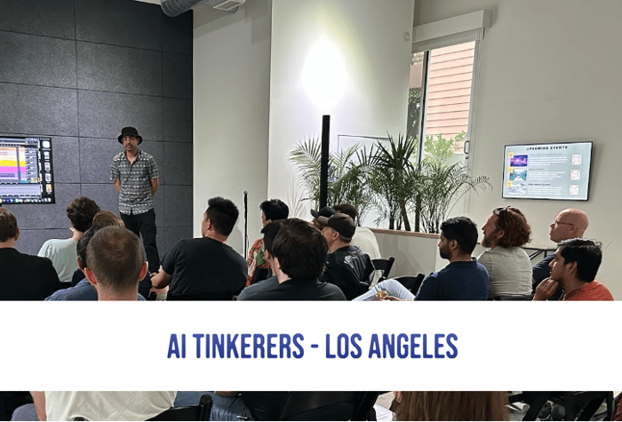 A photo of a presentation being given to a group of people in a room.  A speaker stands in front of a screen displaying information, while the audience sits in chairs.. Text: AI Tinkerers - Los Angeles
UPCOMING EVENTS