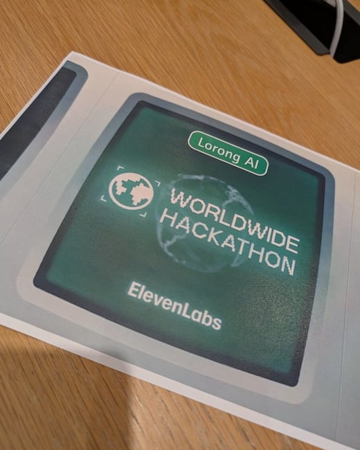 A close-up photograph of a printed flyer or sign promoting the "Lorong AI Worldwide Hackathon" sponsored by ElevenLabs, displayed on a light brown wooden surface.