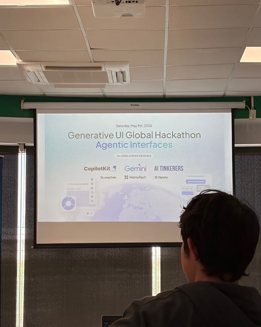 A person is seen from behind, looking at a projector screen displaying a slide for the 'Generative UI Global Hackathon' featuring various tech logos.