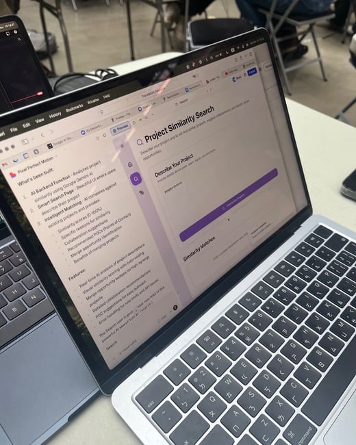 A close-up photograph of two laptops on a table in an indoor setting, focusing on the screen of the foreground laptop which displays a web application interface for 'Project Similarity Search'.