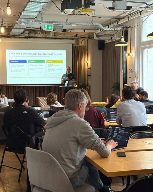 A man is giving a technical presentation about Google Cloud Run to an audience in a modern office or coworking space.