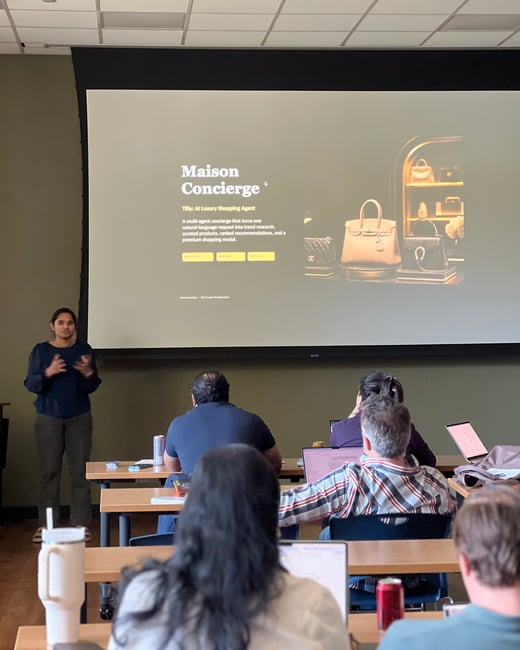 A woman is giving a presentation about an AI luxury shopping agent called Maison Concierge to an audience in a classroom-style setting.