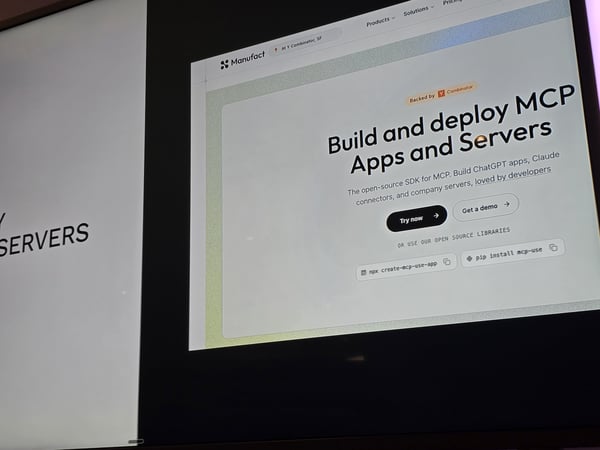 A photograph of a digital screen displaying the landing page for 'Manufact', a platform for building and deploying MCP apps and servers.