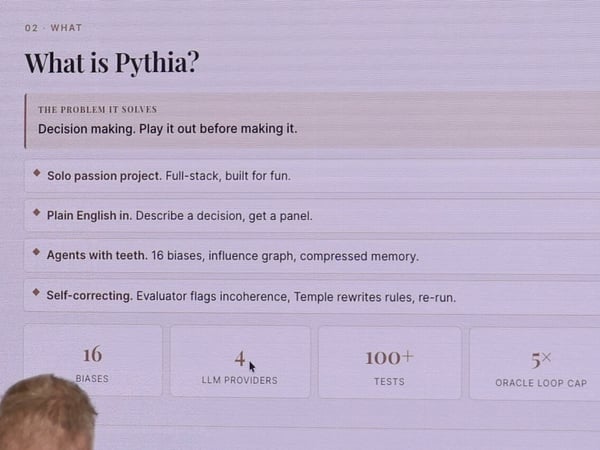 A photograph of a presentation slide titled 'What is Pythia?' which explains the project's goals and technical features.