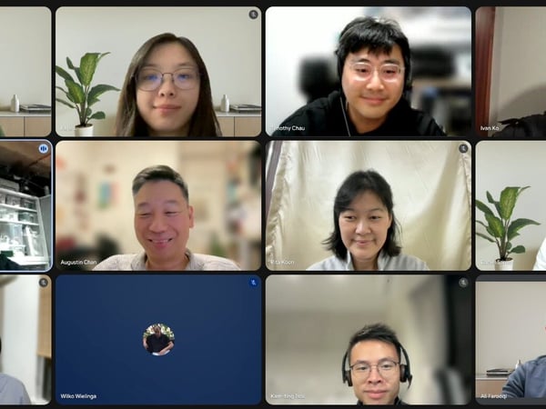 A screenshot of a virtual video conference meeting showing a grid of twelve tiles, with eleven participants visible on camera and one tile displaying a profile icon.