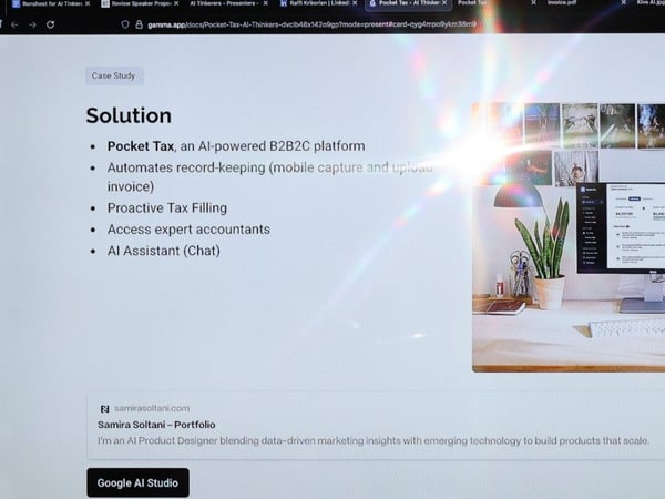 A photograph of a computer monitor displaying a digital presentation slide about an AI-powered platform called 'Pocket Tax'. A bright lens flare is visible on the screen, partially obscuring some text.