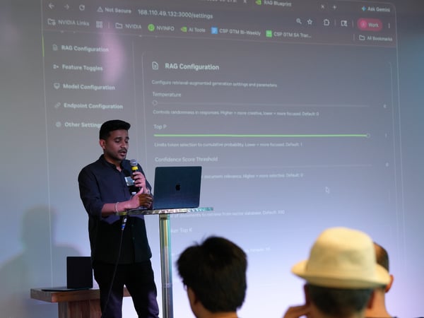 A man stands at a podium speaking into a microphone while presenting a RAG Configuration settings page projected onto a large screen behind him.