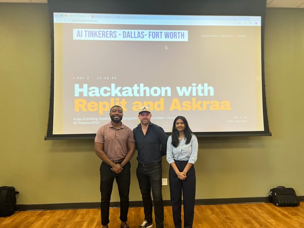 Three people are standing in front of a large projector screen displaying information about an AI Tinkerers hackathon event in Dallas-Fort Worth.